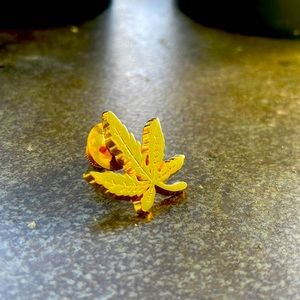 Gold cannabis leaf lapel pin 1”